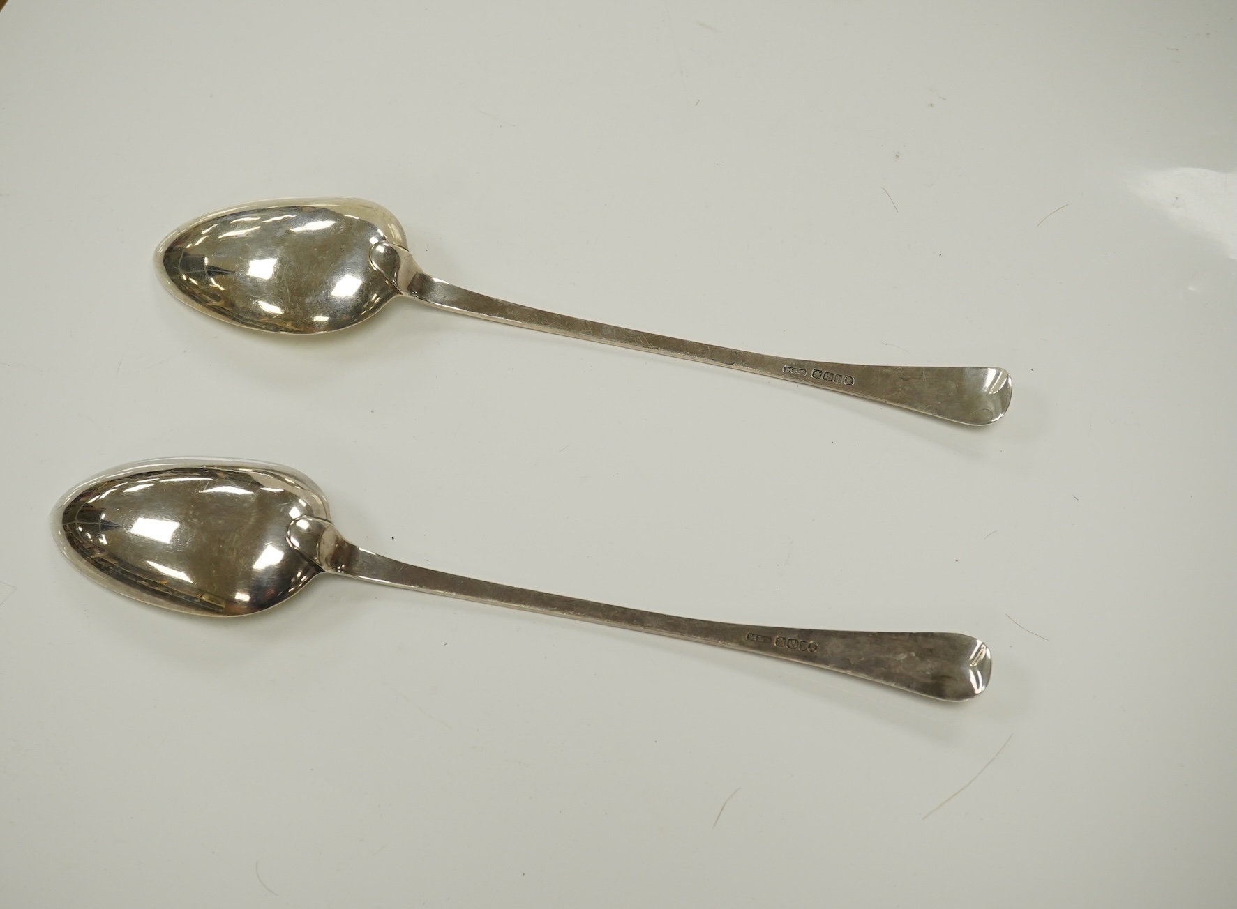 A pair of early Victorian Scottish silver Old English feather edge pattern basting spoons, Marshall & Sons, Edinburgh, 1840, 30cm, 5.8oz. Condition - fair